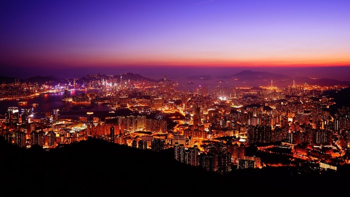 Cityscape at sunset with purple and orange sky