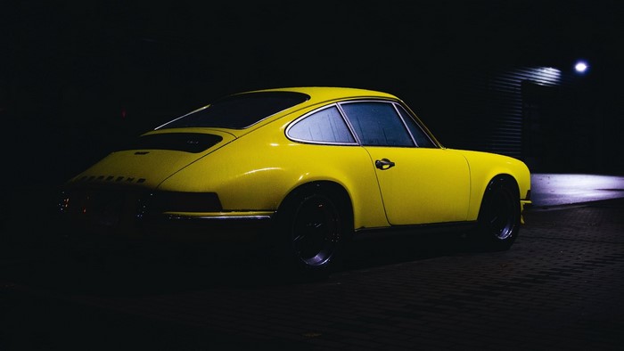 Yellow Porsche 912 parked at night