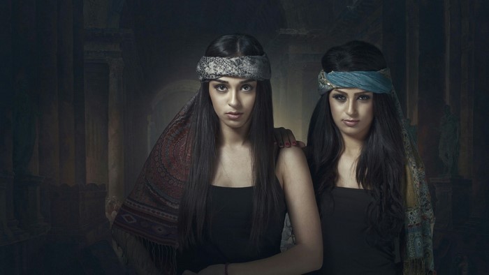 Two young women with headbands in ancient setting
