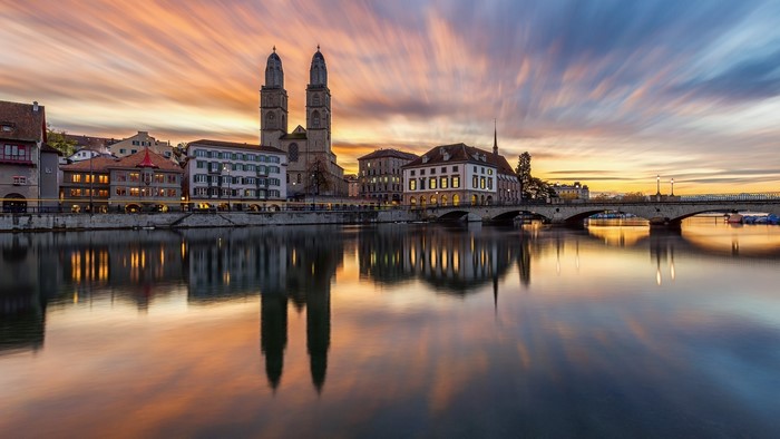 Zurich cityscape with river and bridge at sunset