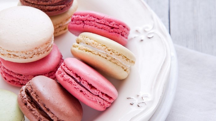 Assortment of colorful macarons on a white plate