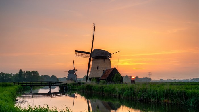 Windmills at sunset over a canal