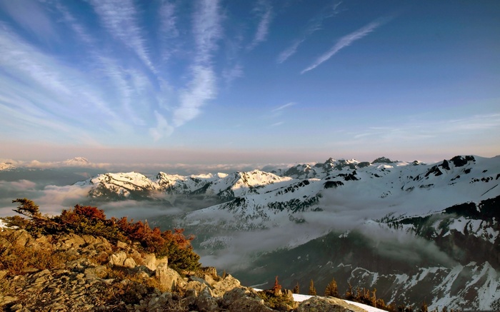 Snow-capped mountains under a cloudy sky