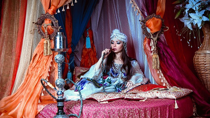 Girl smoking hookah in a tent