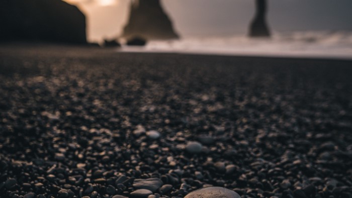 Pebble beach with rock formations and ocean waves