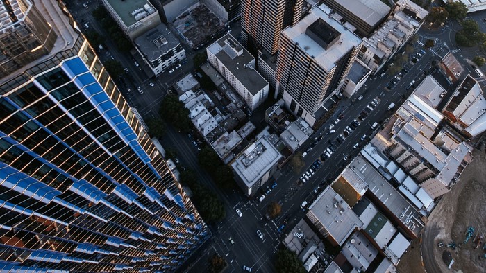 Aerial view of a city street with buildings and cars