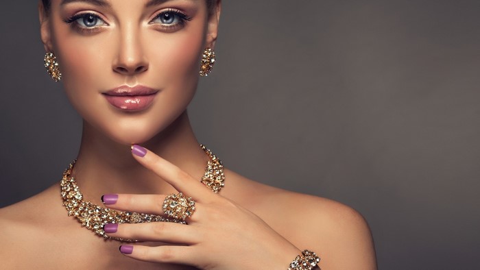 Woman with diamond jewelry and purple nails