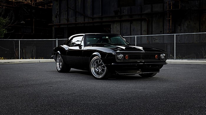Black Chevrolet Camaro parked on asphalt