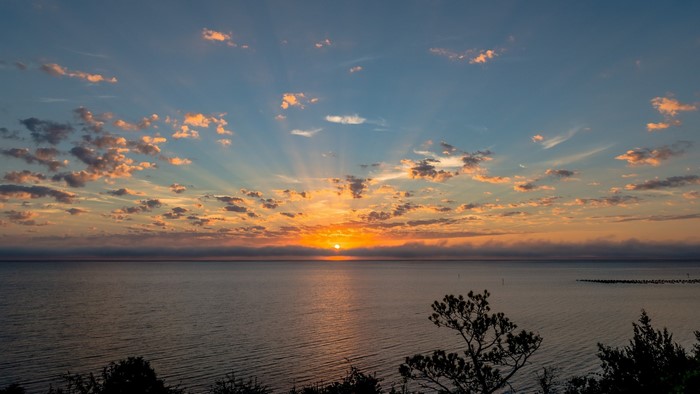 Sunset over the ocean with clouds
