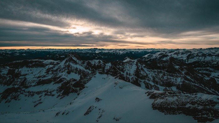 Snowy mountain range at sunset