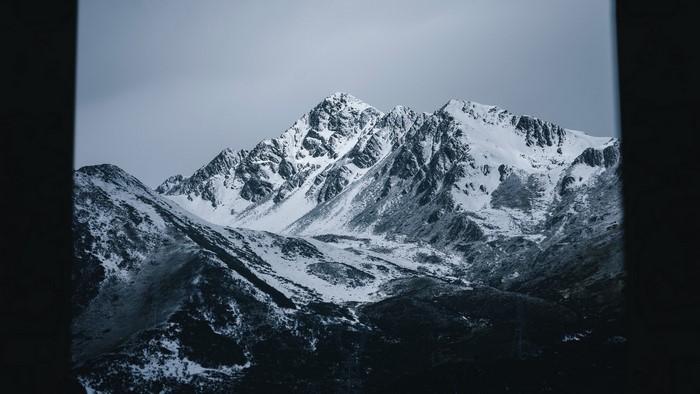 Snow-covered mountains under a cloudy sky