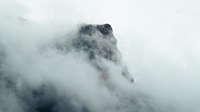 Rock formation shrouded in mist