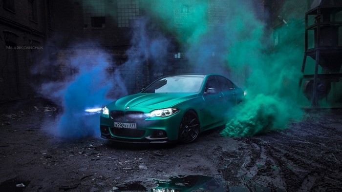 Green BMW F10 with blue and green smoke