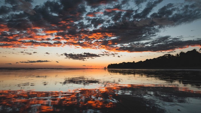 Sunset over a beach with reflections