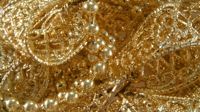 Close-up of gold lace and beads