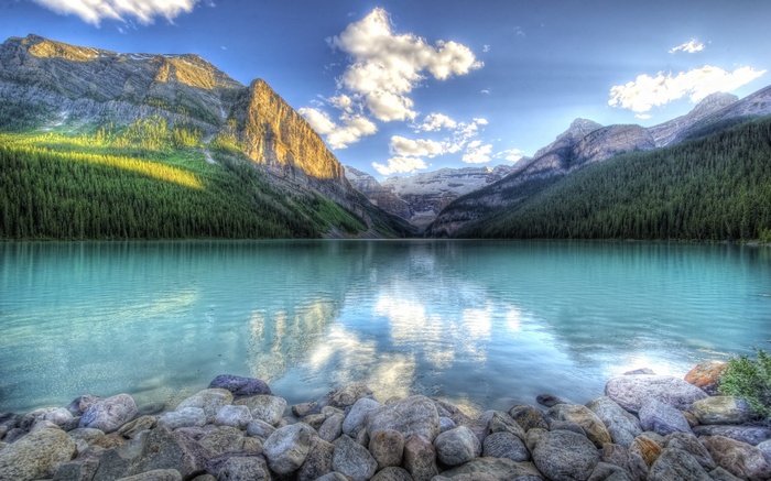 Turquoise lake and mountains with rocky shore