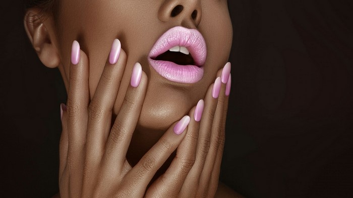Woman with pink ombre nails and lips