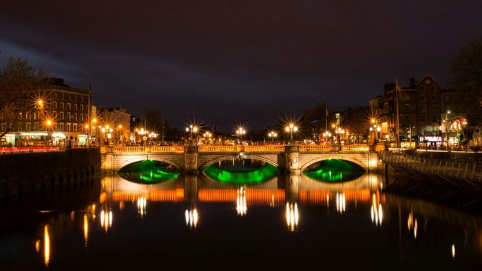 Bridge over river at night with reflections