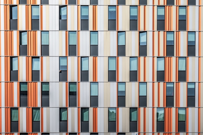 Modern building facade with colorful vertical stripes and windows