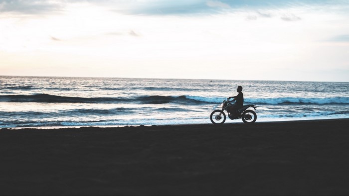 Motorcyclist on a Beach at Sunset