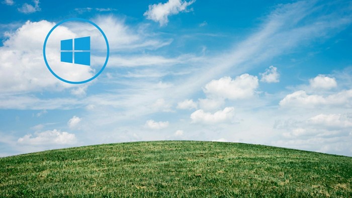 Windows logo over a grassy hill and sky