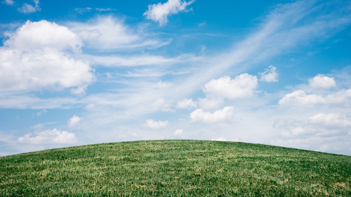 Green Hill Under Blue Sky with Clouds