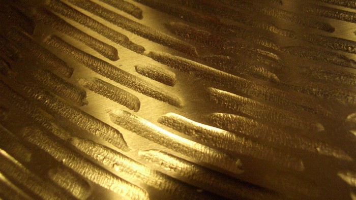 Textured metallic surface with diagonal lines