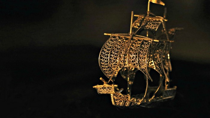 Intricate golden filigree ship model