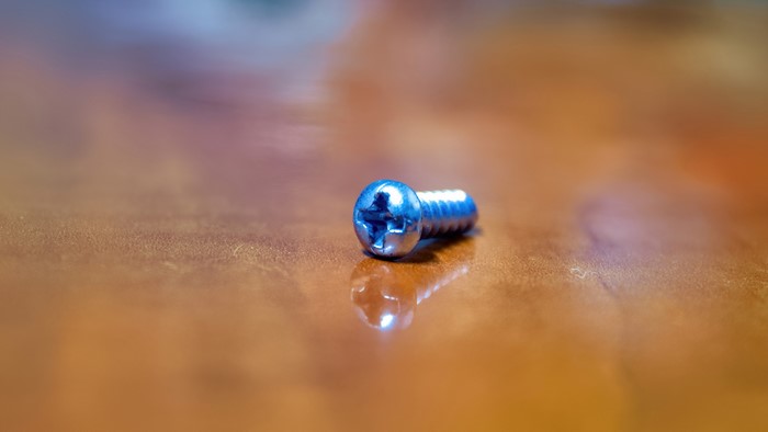 4K Screw on a Wooden Surface