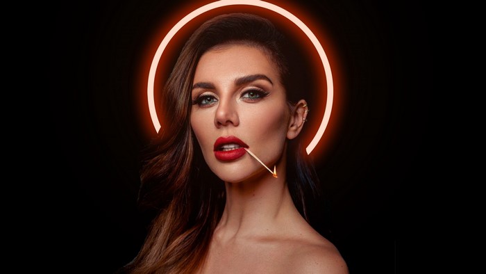 Woman with match in mouth and halo
