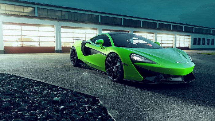 Green McLaren Supercar in front of Garage