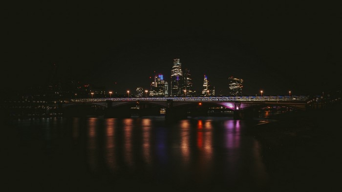 Night city skyline with bridge and river