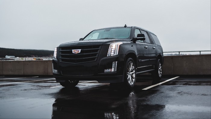 Black Cadillac Escalade on a Wet Parking Lot