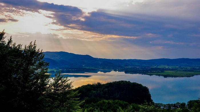 Sunbeams over a lake and mountains