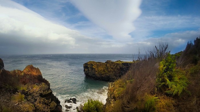 Rocky coastline with ocean and clouds