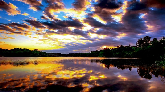 Sunset over a lake with colorful clouds