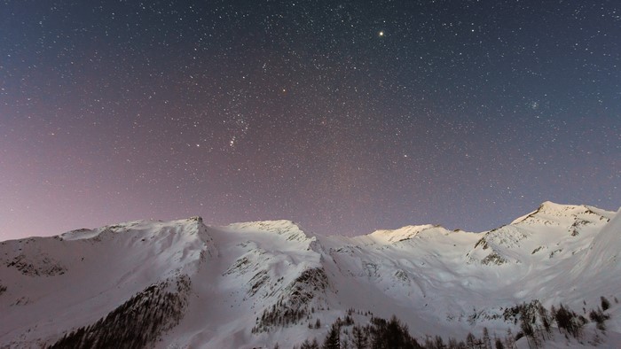 Snowy Mountains Under a Starry Night Sky