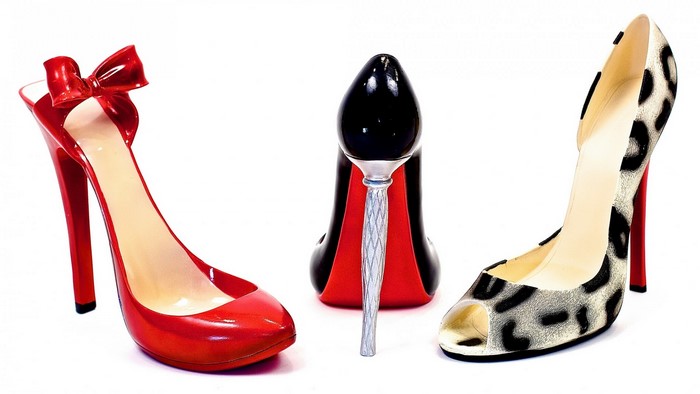 Three high-heeled shoes with red soles