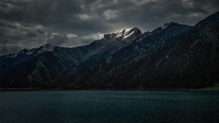Lake and Mountains Under Dramatic Clouds