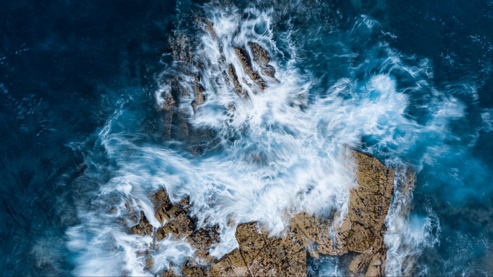 Waves crashing on rocky shore