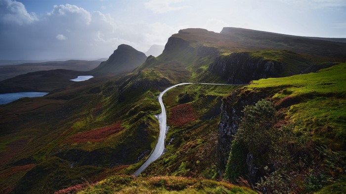 Winding road through a mountainous landscape with lakes
