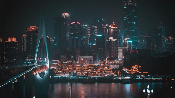 Night city skyline with illuminated bridge