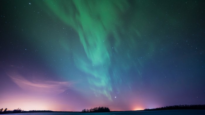 Northern Lights over a dark landscape