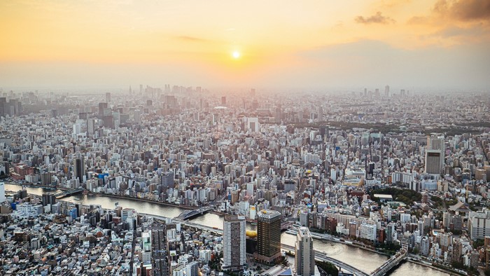 Aerial view of a sprawling megapolis at sunset
