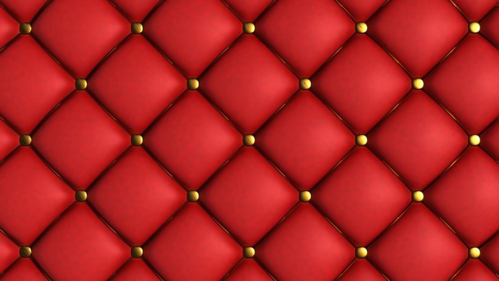 Red tufted upholstery with gold buttons