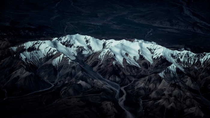 Dark Snowy Mountain Range Aerial View