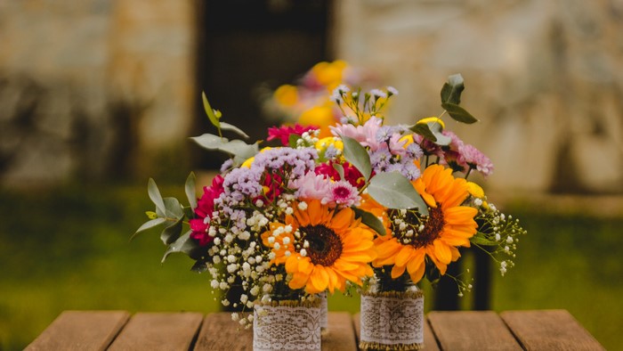 Two bouquets of sunflowers and other flowers