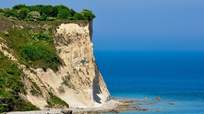 White chalk cliffs overlooking the blue sea