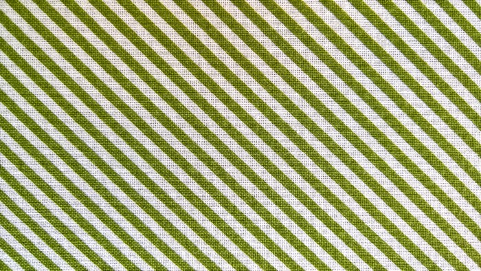 Green and white diagonal striped fabric texture