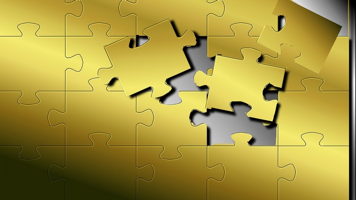 Golden puzzle pieces with missing pieces